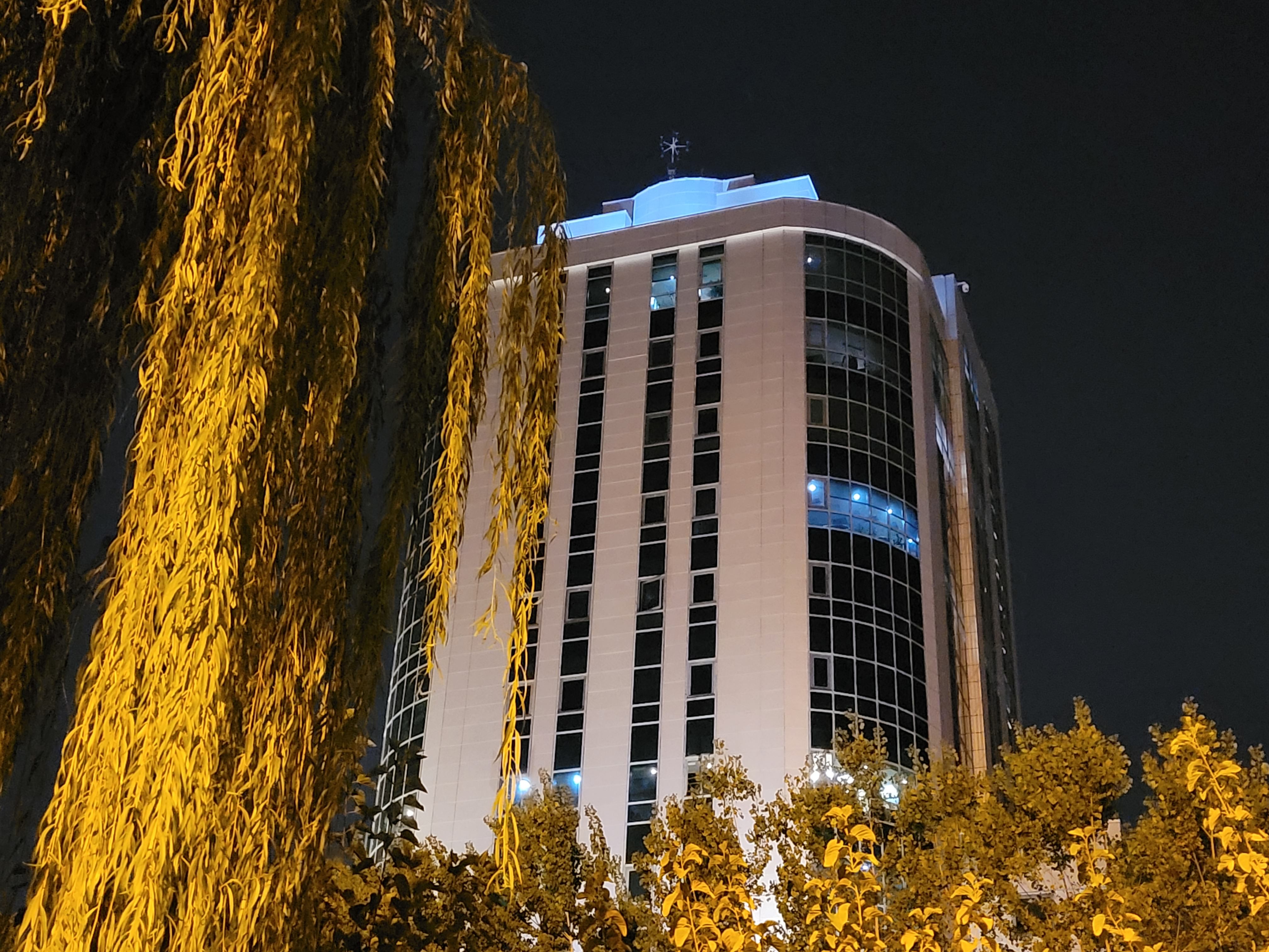 نمونه عکس 2x دوربین واید گلکسی زد فولد ۲ در تاریکی - ساختمانی در میان درختان پارک آب و آتش تهران
